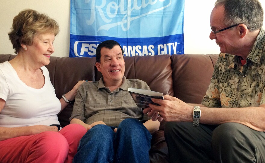 Nick Fugate (center) with his parents, Julie and Ron, has been adjusting to life on Kansas' waiting list to get life-assistance services through Medicaid.