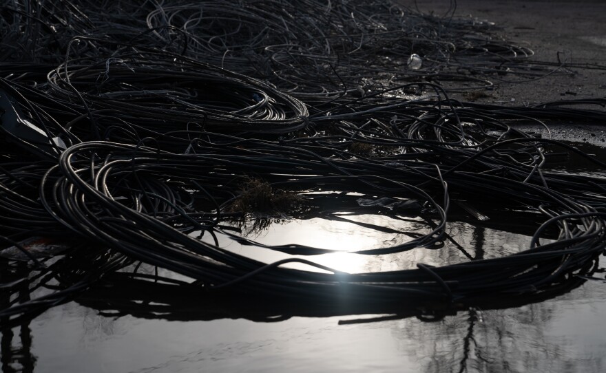 Piles of used and damaged wires are set aside to be recycled in a lot in Lyman.