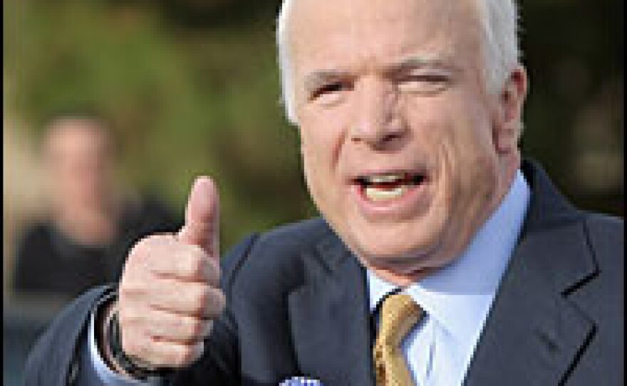 Republican presidential nominee John McCain gestures to supporters after casting his vote at the polling place in the Albright United Methodist Church in Phoenix on Tuesday.