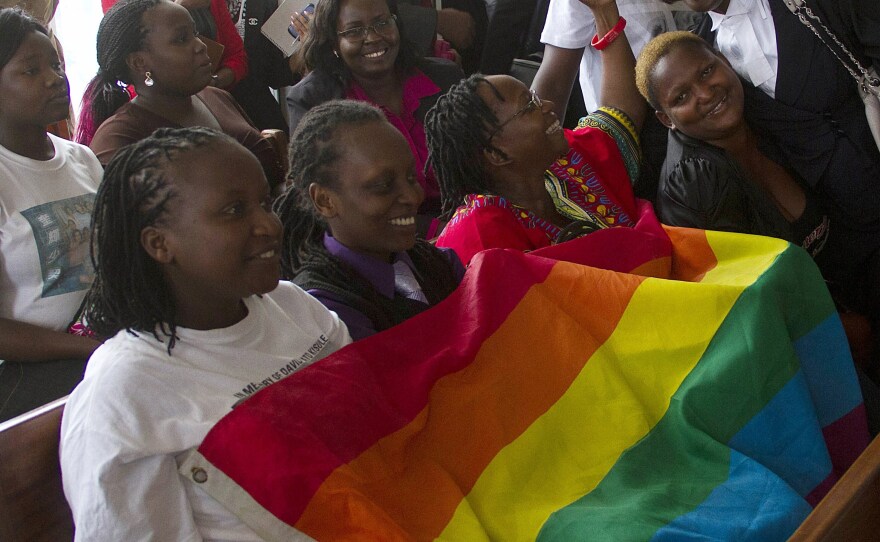 Members of Uganda's gay community and gay rights activists react after the constitutional court overturned an anti-gay law.