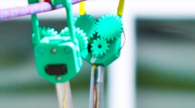 The SkySweeper robot can examine power lines autonomously by pulling itself along high wires. 