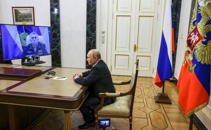 Russian Strategic Missile Forces chief, Col. Gen. Sergei Karakayev, left on the screen, reports to President Vladimir Putin on a successful test launch of the Sarmat intercontinental ballistic missile at the Kremlin in Moscow, Tuesday, May 12, 2026.