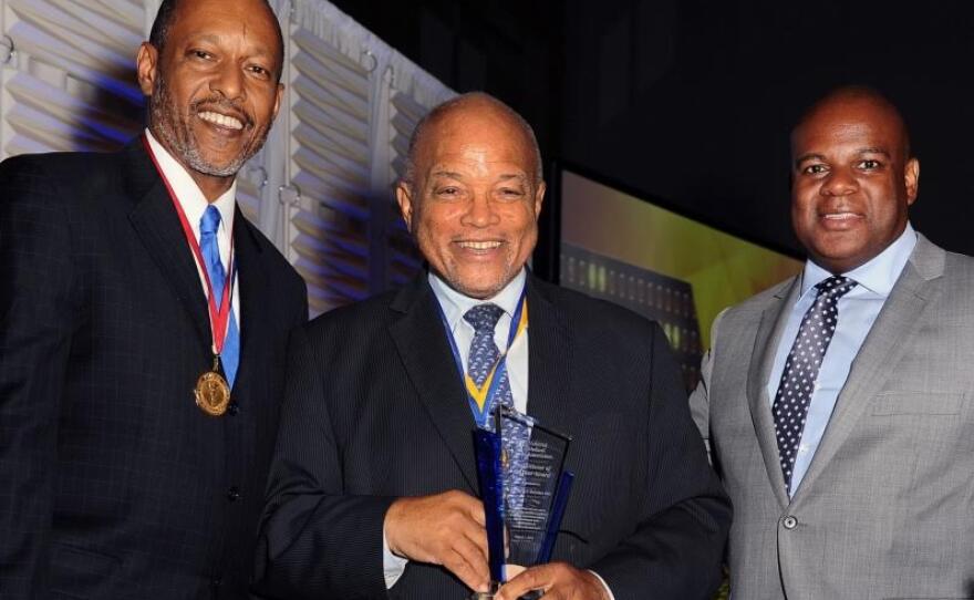 Richard Butcher, center, accepts the "Practitioner of the Year" award at a National Medical Association event in Detroit, Aug. 1, 2015.