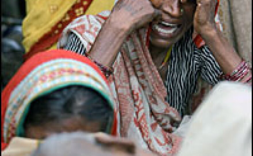 Indian flood-affected villagers mourn for Soukhi Paswan, who died at a temporary shelter set up along the national highway beside their flooded villages at Muzaffarpur, some 100 kms north of Patna, on Monday. Paswan, allegedly received no medical treatment for ten days because of the floods. Among the millions of people forced from their homes by floods across South Asia many were desperate for food and drinking water, with India's Bihar state the worst hit.
