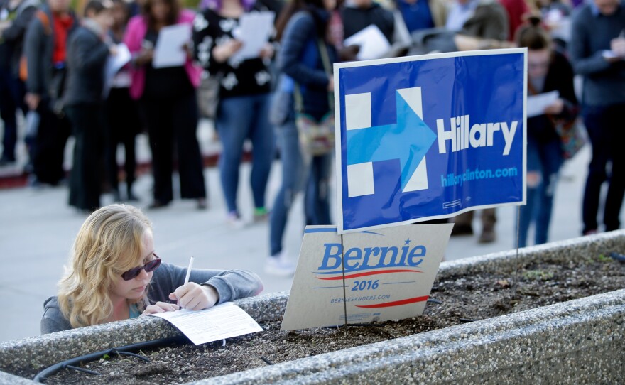 Kara Bonham registers to vote for the Democratic caucus at the University of Nevada on Saturday in Reno, Nev.