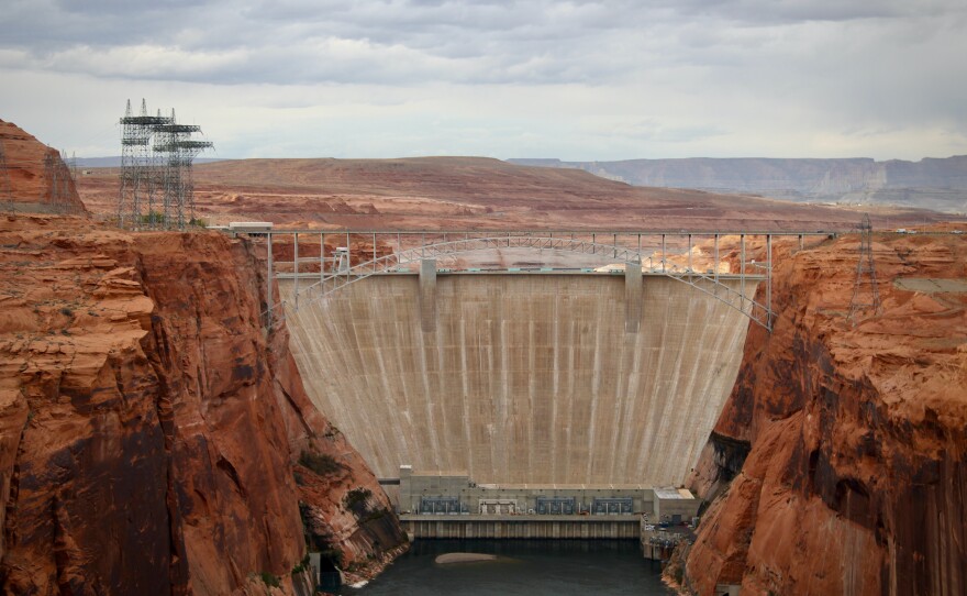 Glen Canyon Dam holds back Lake Powell near Page, Ariz. Water levels behind the dam have dropped so low that invasive smallmouth bass are able to swim downstream, and now threaten native fish in the Grand Canyon.