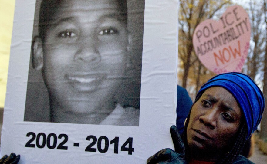 A protester holds up a picture of 12-year-old Tamir Rice in a December 2014 demonstration in Washington, D.C.