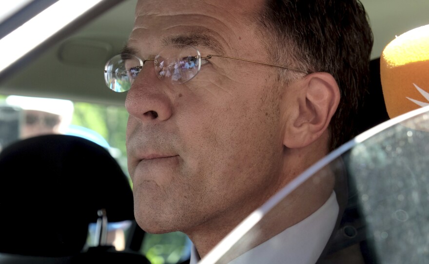 Dutch Prime Minister Mark Rutte sits in a car as he leaves Palace Huis ten Bosch in The Hague, Netherlands, Saturday, July 8, 2023 after he informed King Willem-Alexander that his coalition government has resigned.