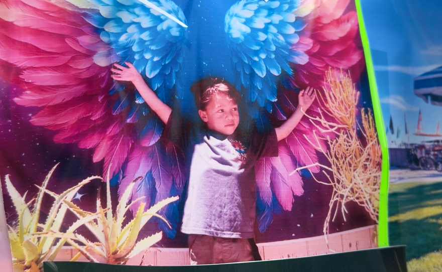 Hudson O’Laughlin outstretches his arms in a photo displayed at his memorial in Pacific Beach on Jan. 21, 2026.