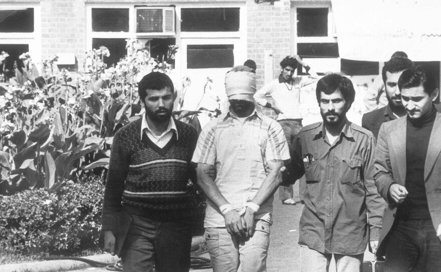 A hostage held at the U.S. Embassy in Tehran, Iran is shown to a crowd by Iranian students. November 8, 1979.