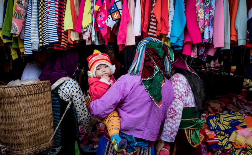 Shoppers explore the goods on display in Ha Giang, Vietnam. The country's textile industry was expected to be one of the biggest winners from the Trans-Pacific Partnership, which would have provided tariff-free access to U.S. markets. Under the new agreement, the industry is still expected to gain — if not nearly as much.