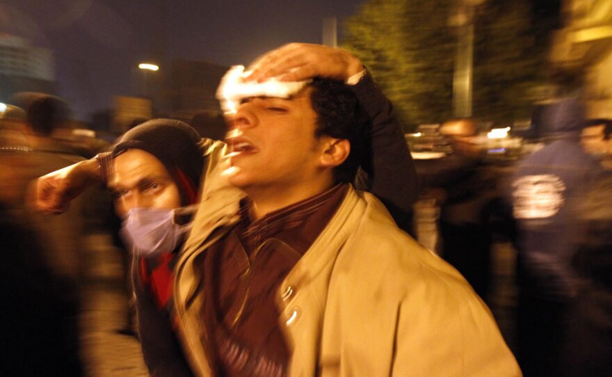 A paramedic helps a wounded demonstrator in Cairo's Tahrir Square on Wednesday.