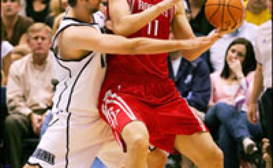 Yao Ming of the Houston Rockets is guarded by Mehmet Okur of the Utah Jazz in April during Game Three of the quarterfinals of the NBA playoffs. Follwing Yao Ming's success, the NFL is searching for its own Chinese star.