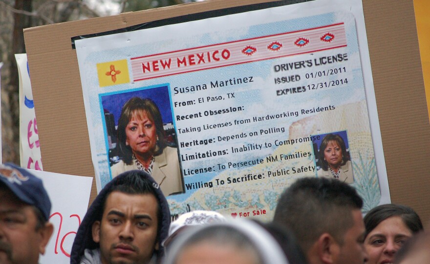 Immigrant advocates use an image of New Mexico Gov. Susana Martinez on a mock state driver's license during a 2012 rally in Santa Fe, N.M., to protest her proposal to repeal a state law that allows undocumented immigrants to obtain driver's licenses.