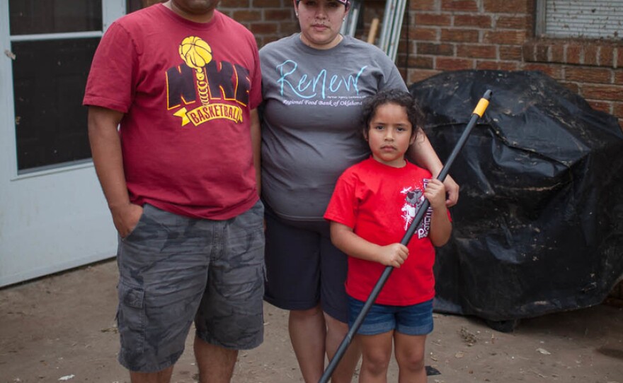 Eli and Maria Sanchez with their daughter, Kaylee, 6 at their home in Moore, Okla., on Friday.