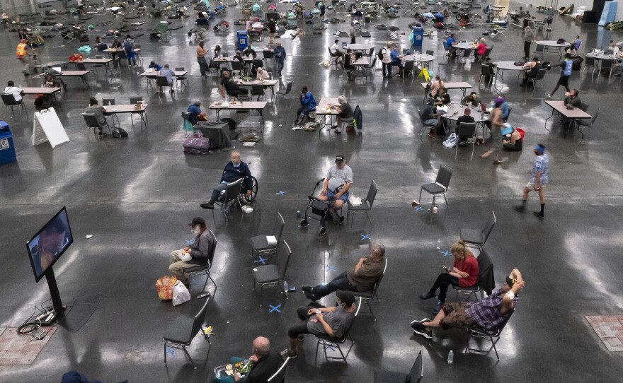 Portland residents wait inside the Oregon Convention Center, which was repurposed as an emergency cooling center during a heat wave in June 2021. Hundreds of people died in the Pacific Northwest due to the heat wave.