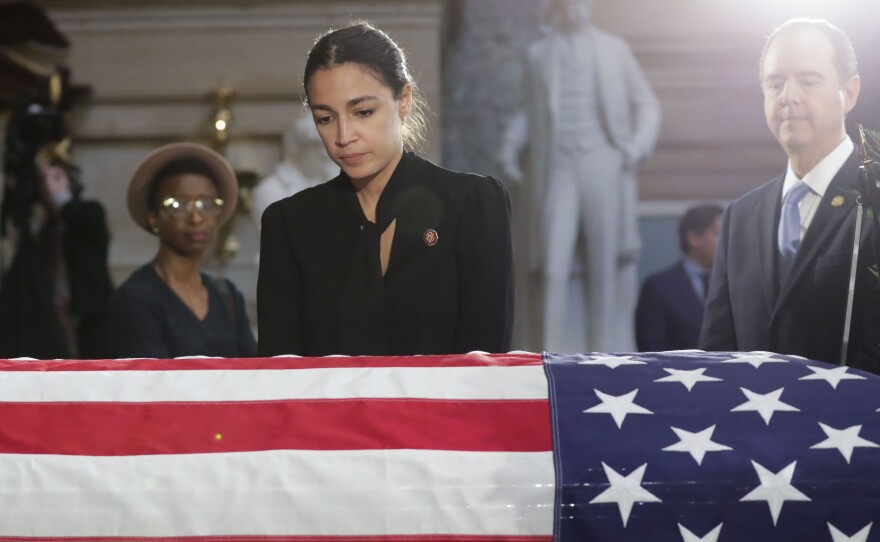 Rep. Alexandria Ocasio-Cortez, D-N.Y., stops to pay her respects at the Capitol on Thursday.