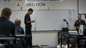 Recruits role play responding to a call where a man has been injured.
