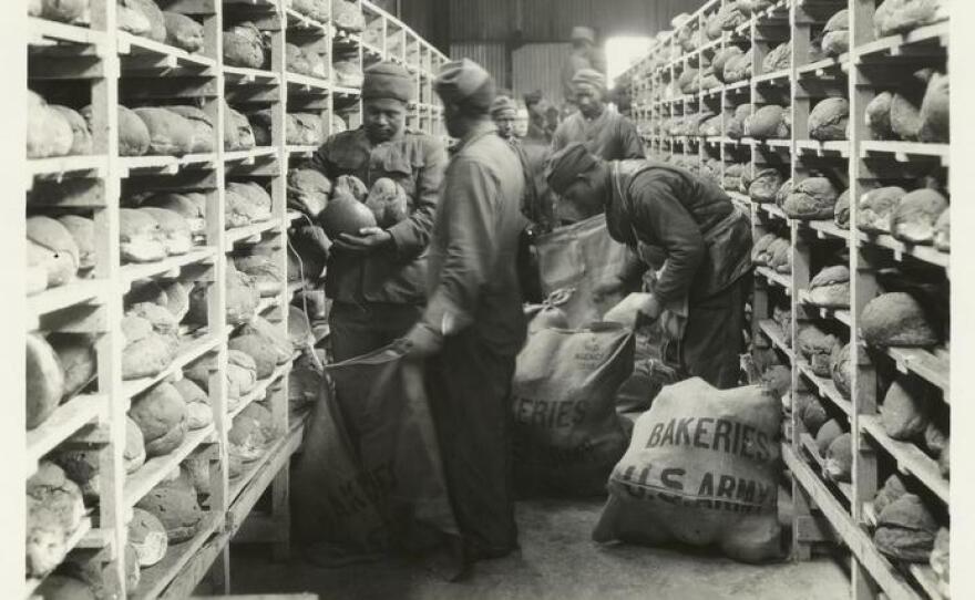 U.S. soldiers sack bread ready for shipment, shortly after the end of World War I.