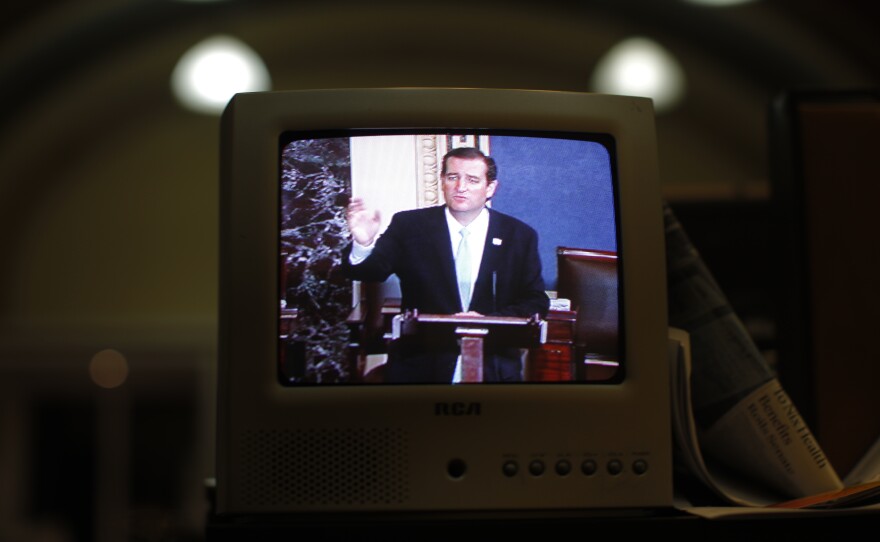 Seen on a TV in the Senate Press Gallery, Sen. Ted Cruz, R-Texas, speaks during the seventh hour of his 2013 filibuster in opposition to the Affordable Care Act. President Biden is advocating for a so-called "talking filibuster."
