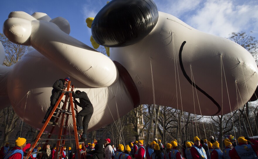 Workers prepare the giant Snoopy balloon before the 87th Annual Macy's Thanksgiving Day Parade on Thursday in New York.