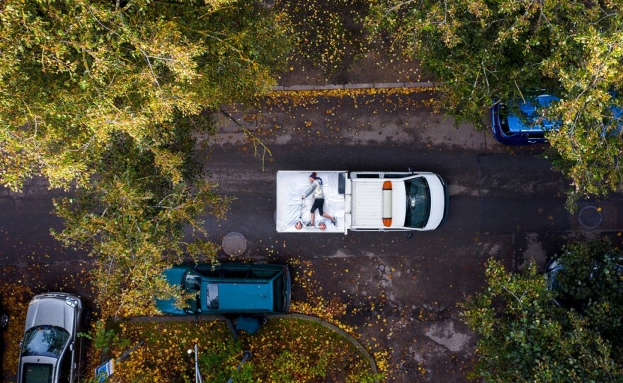 A photo from Adas Vasiliauskas' series "COVID Self-Isolation Sucks," which earned a commendation from this year's Drone Photo Awards. The set of images, taken on the streets of his native Lithuania, plays on people's desire to "live life" despite living in a "COVID nightmare," he says. In this particular photo, a man posing on the bed of a truck pretends to ride his scooter.