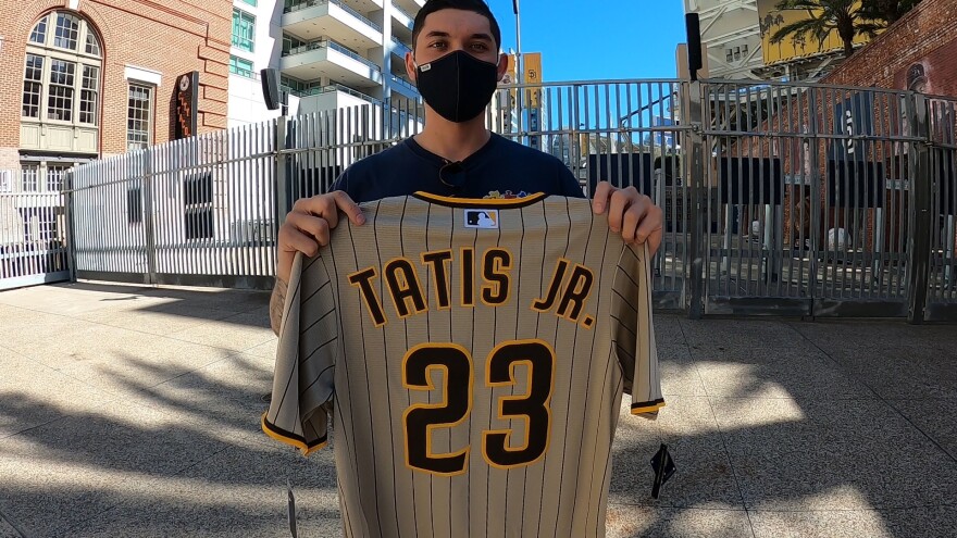 Tony Trinh, a Padres fan from Rancho Bernardo, holds up a Tatis Jr. jersey in front of Petco Park in Downtown San Diego, Calif. Feb. 18, 2021.