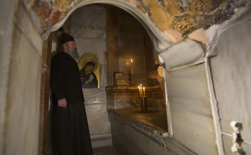 A Greek priest stands inside the renovated Edicule in the Church of the Holy Sepulchre on Monday.
