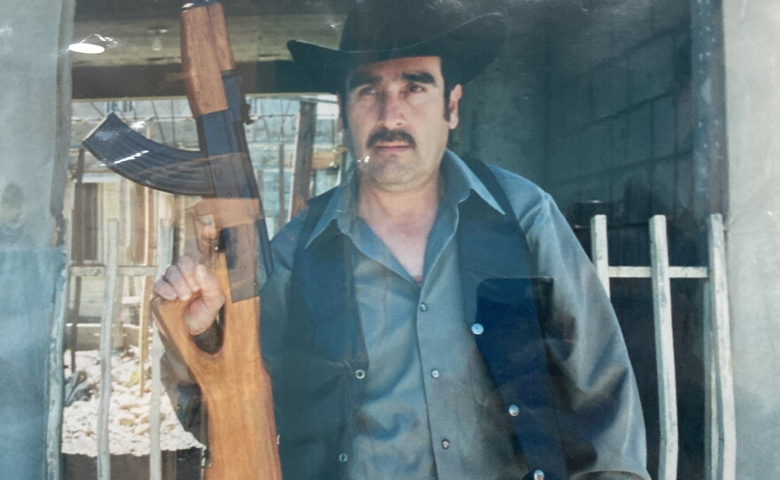 A younger Emilio Montiel on set, holding a prop rifle during the making of one of his early films.