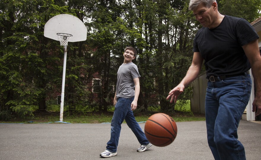 Ed Damiano and his son David,  15, play basketball at home in Acton, Mass. Ed has invented a device he hopes will make David's diabetes easier to manage.