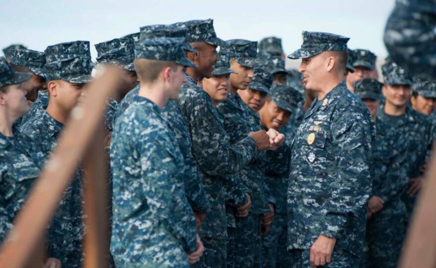 Master Chief Petty Officer of the Navy Mike Stevens greets crew members aboard USS Carl Vinson, July 2014.