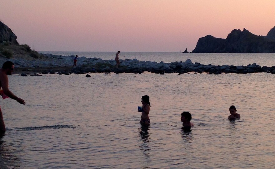 Families play on the beach near the village of Thanos, Lemnos. The island has more than a hundred beaches. Greek tourists like Lemnos because it's affordable and relaxing, and foreign tourists like its unspoiled beauty and traditional charm.