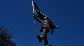 A statue of a man holding a flag covering his face, and signed 'Banksy', which has appeared in Waterloo Place in London, Thursday, April 30, 2026.
