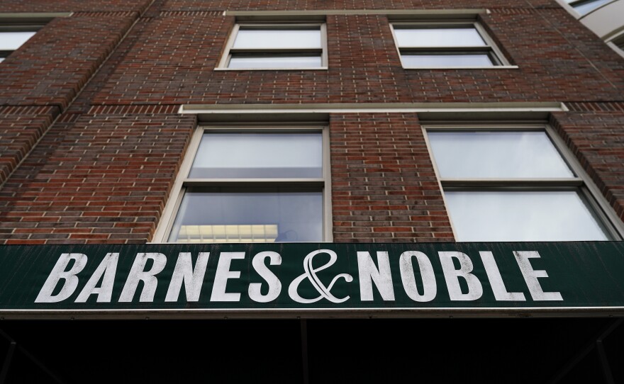 The sign for a Barnes & Noble bookstore hangs above the entrance to one of its locations in Brooklyn earlier this year. The book retailer and Elliott announced Friday that they have agreed to a sale price of about $683 million.