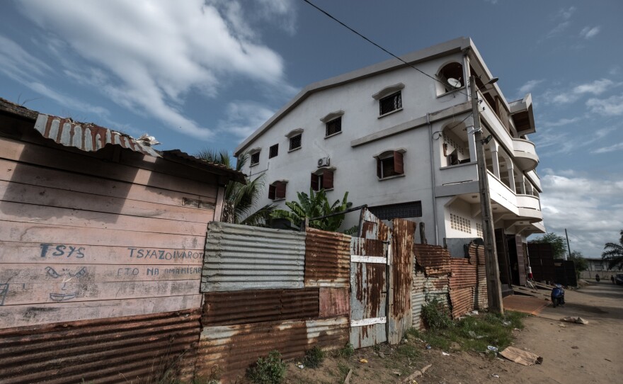 A building owned by a vanilla trader looms over small corrugated zinc shacks in the town of Antalaha, Madagascar.