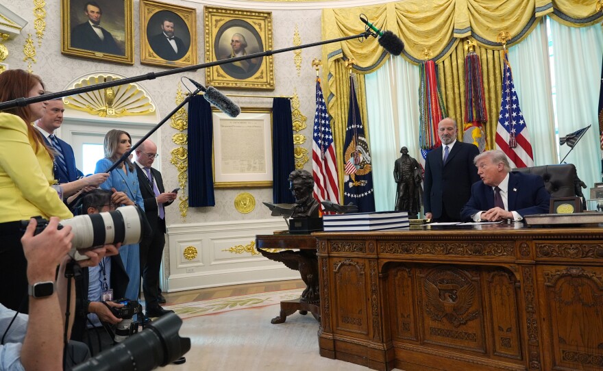 President Donald Trump answers questions from reporters after signing an executive order in the Oval Office of the White House Tuesday, March 31, 2026, in Washington, as Commerce Secretary Howard Lutnick listens.