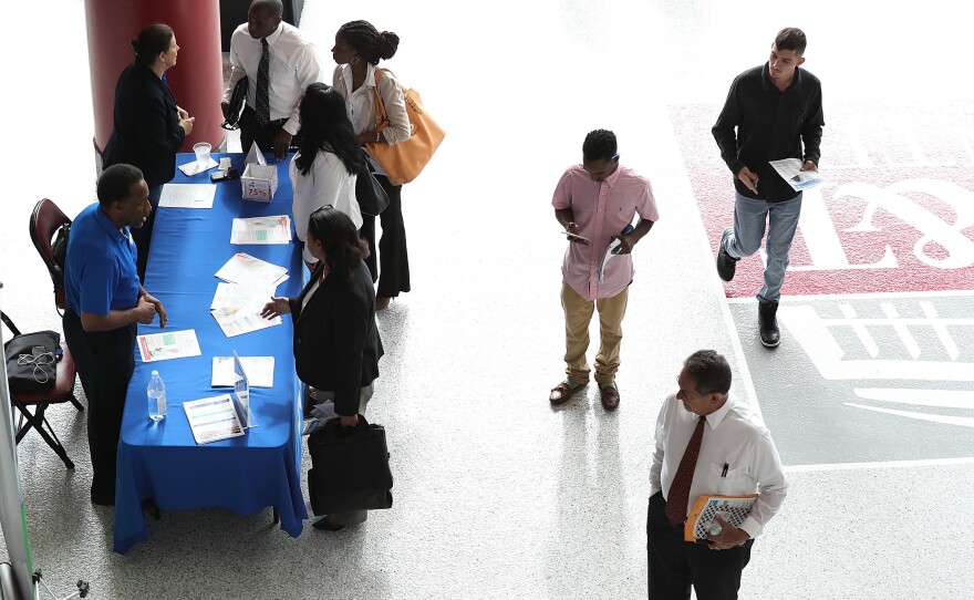 People attend the JobNewsUSA job fair at the BB&T Center on Nov. 15 in Sunrise, Fla.