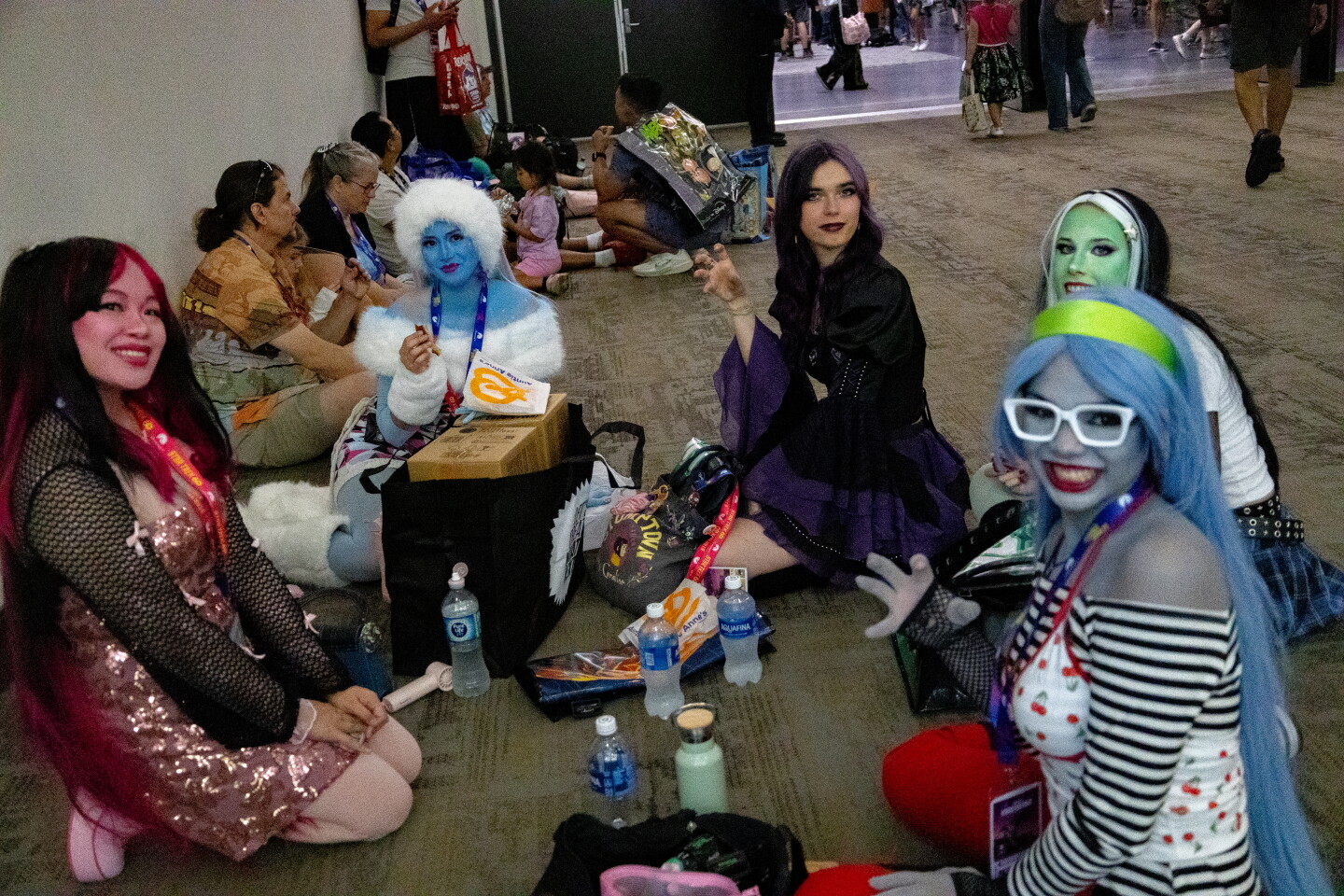 Friends take a break during Comic-Con on day one, July 23, 2026.