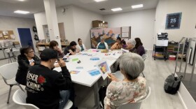 A group of adults sit at a table at the Oceanside Reads learning center to learn English. Oct. 24, 2023. 