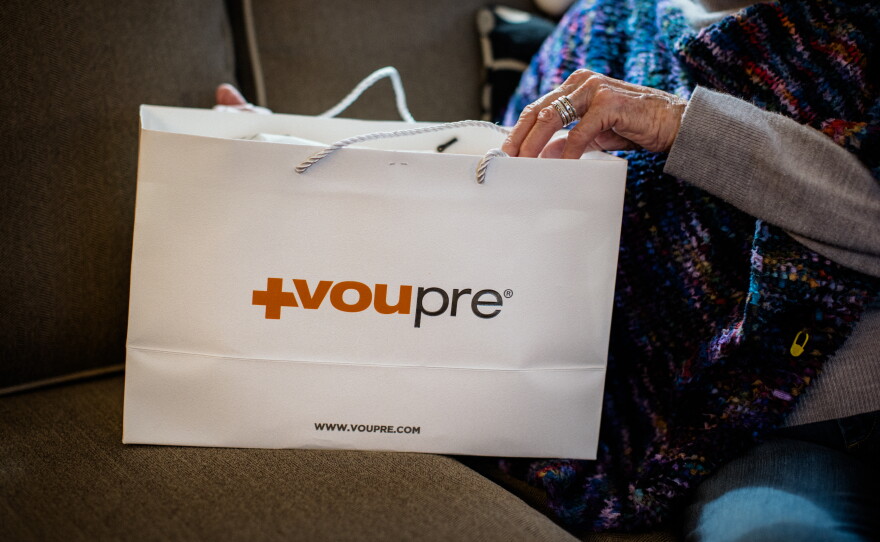Suzann Roberts holds a paper bag of Voupre skincare products from Beauty Essentials in Ann Arbor, Michigan.