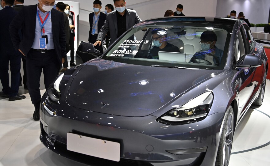 A Tesla Model 3 is seen during the 19th Shanghai International Automobile Industry Exhibition in Shanghai, China, on April 19. Hertz said it was hiring quarterback Tom Brady to promote the Tesla Model 3s it's buying to diversify the rental car company's fleet.
