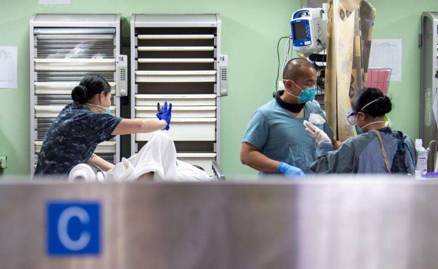 Sailors treat a patient aboard the hospital ship USNS Mercy, which is docked off the coast of Los Angeles, in this undated photo.