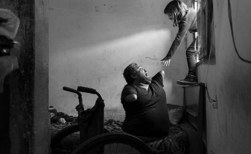Jorge, age 40, plays with his 8-year-old daughter Ángeles in their house near Buenos Aires, Argentina. Asked what it is like to live through a pandemic, Jorge answered, "I was born without legs and without arms. I know very well what despair is, I have been living my own pandemic and isolation ever since. This is nothing new to me."