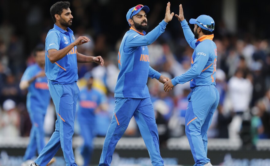 India teammates celebrate after winning the Cricket World Cup match between India and Australia at the Oval in London on June 9. The team will face Pakistan this Sunday.
