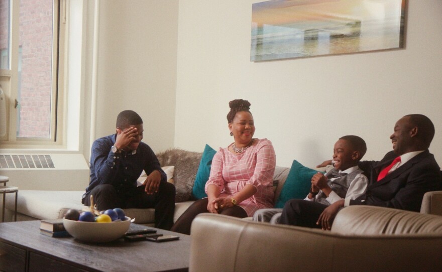Tani, center, shares a laugh with his family — big brother Austin, his mom Oluwatoyin and his dad Kayode. The Adewumis came to the U.S. from Nigeria in June 2017.