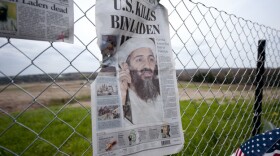 A newspaper left by visitors on May 2 in Shanksville, Pa., at the fence surrounding the crash site of Flight 93. The chairmen of the 9/11 Commission say the U.S. has improved security over the past decade, but gaps in the system remain.