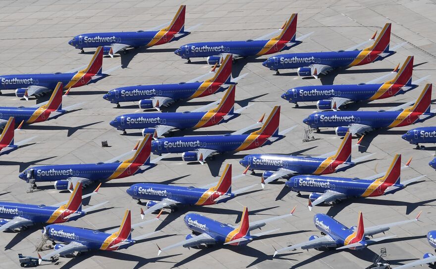 Southwest Airlines Boeing 737 Max aircraft are parked on the tarmac after being grounded, at the Southern California Logistics Airport in Victorville, Calif., on March 28. Boeing said its financial outlook is uncertain as it deals with the 737 Max grounding.
