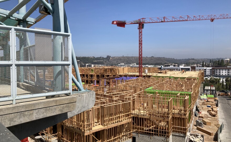 A dense, affordable housing development goes up in Grantville, as seen from the platform of a trolley stop that will serve its residents. May 6, 2022