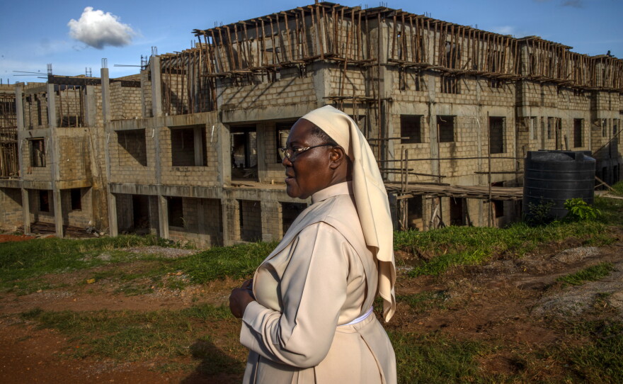 Sister Jane Francis Nakafeero stands outside the Little Sisters of St. Francis premises in Nkokonjeru, Uganda. After more than 25 years working in healthcare, Sister Jean Francis helped advocate for a partnership between the Little Sisters of St. Francis and the African Palliative Care Association to improve end-of-life care.