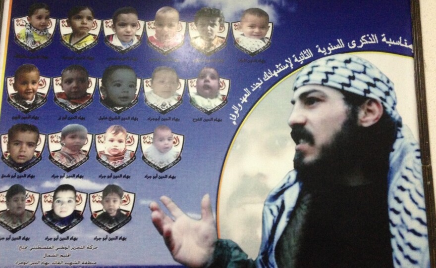 A poster of Baha Abu Jarad, a member of the Fatah movement, who was killed by the rival Hamas faction, according to his family. The small photos show children that were named after Baha.